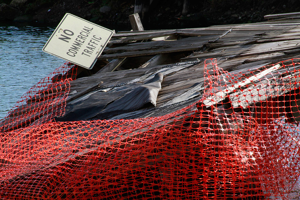 Close up shot of the sunken dock and the orange plastic fencing