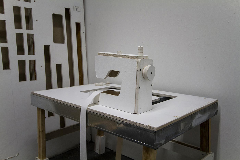 Installation of a sewing machine made out of sheetrock.